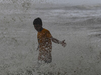 A boy is trying to escape from a wave at Kuakata beach area in Kuakata, Bangladesh, on May 26, 2024, ahead of Cyclone Remal landfall. Bangla...