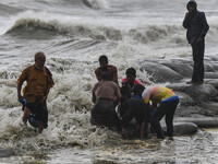 Local people are gathering on an embankment to repair the embankment in Kuakata, Bangladesh, on May 26, 2024, ahead of Cyclone Mocha's landf...