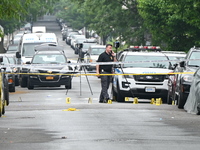 Evidence markers are down on the ground, highlighting the crime scene where an emotionally disturbed 26-year-old male is being shot and kill...