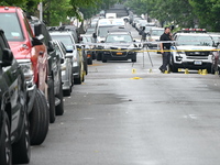 Evidence markers are down on the ground, highlighting the crime scene where an emotionally disturbed 26-year-old male is being shot and kill...