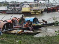 Fishermen are tying their boats with rope during the high alert of Cyclone Remal in Kolkata, India, on May 26, 2024. Cyclone Remal is intens...