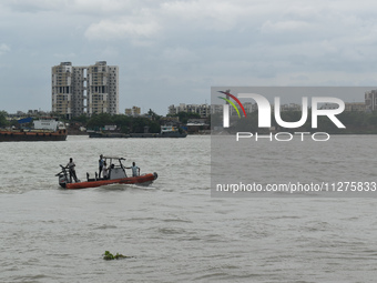Kolkata Police River traffic guard members are patrolling the river Ganges during the high alert of cyclone Remal in Kolkata, India, on May...
