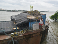 A person is tying his boat to the jetty during the high alert of Cyclone Remal in Kolkata, India, on May 26, 2024. Cyclone Remal is intensif...