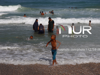 Palestinians are gathering on the beach in Deir el-Balah, central Gaza Strip, on May 26, 2024, amid the ongoing conflict between Israel and...