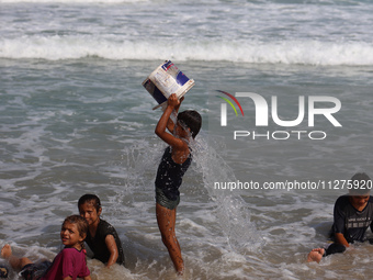 Palestinians are gathering on the beach in Deir el-Balah, central Gaza Strip, on May 26, 2024, amid the ongoing conflict between Israel and...