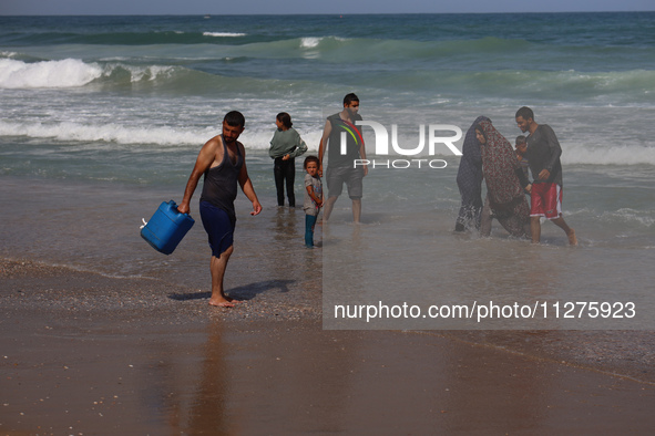 Palestinians are gathering on the beach in Deir el-Balah, central Gaza Strip, on May 26, 2024, amid the ongoing conflict between Israel and...