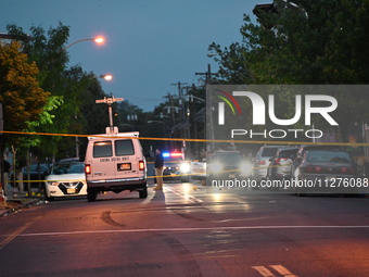 Police are present and evidence markers are highlighting shell casings at the crime scene. One person is killed and two people are injured i...