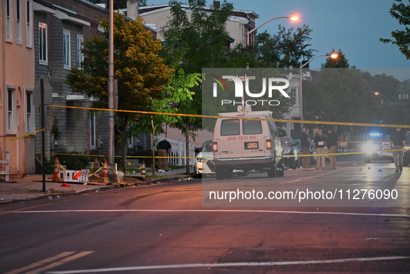 Police are present and evidence markers are highlighting shell casings at the crime scene. One person is killed and two people are injured i...