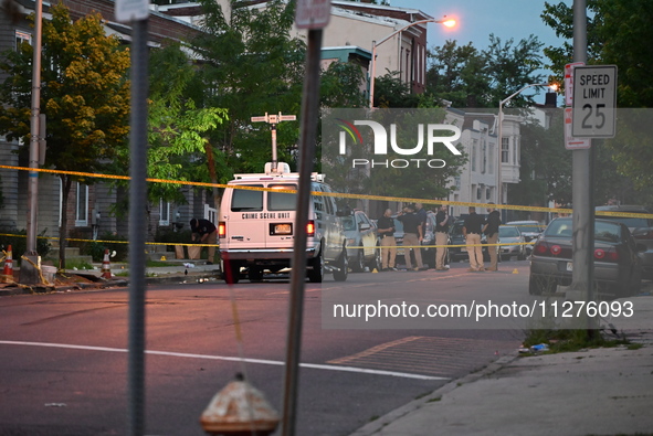 Police are present and evidence markers are highlighting shell casings at the crime scene. One person is killed and two people are injured i...