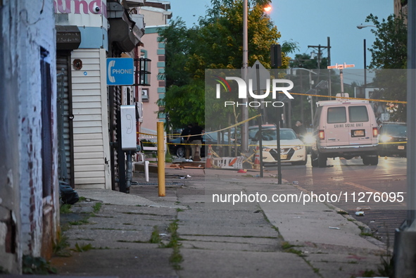 Police are present and evidence markers are highlighting shell casings at the crime scene. One person is killed and two people are injured i...