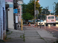 Police are present and evidence markers are highlighting shell casings at the crime scene. One person is killed and two people are injured i...