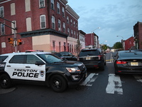 Police are present and evidence markers are highlighting shell casings at the crime scene. One person is killed and two people are injured i...