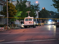 Police are present and evidence markers are highlighting shell casings at the crime scene. One person is killed and two people are injured i...