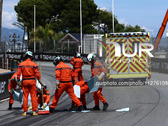 Marshals work after Sergio Perez of Red Bull Racing and Kevin Magnussen of Haas crash during the Formula 1 Grand Prix of Monaco at Circuit d...