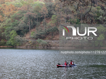 People are kayaking along Sattal Lake in Sattal (Sat Tal), Uttarakhand, India, on April 20, 2024. (