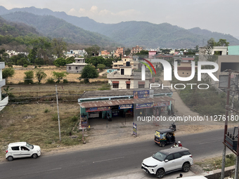 Traffic is moving along a small road in Haldwani, Uttarakhand, India, on April 23, 2024. (