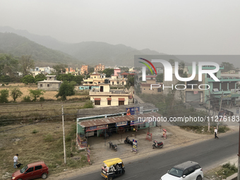 Traffic is moving along a small road in Haldwani, Uttarakhand, India, on April 23, 2024. (