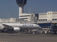 United Airlines Boeing 787-10 Dreamliner passenger plane in front of the terminal and the gates of Athens International Airport ATH in Greec...