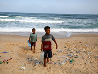 A Palestinian is collecting sea water to wash clothes at the beach in Deir el-Balah, central Gaza Strip, on May 26, 2024, amid the ongoing c...