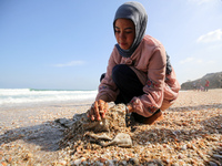 A Palestinian woman is washing clothes at the beach in Deir el-Balah, central Gaza Strip, on May 26, 2024, amid the ongoing conflict between...