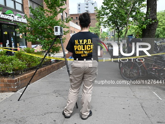 A crime scene investigator is at the scene. A 29-year-old male is being fatally stabbed in Manhattan, New York, United States, on May 26, 20...