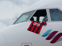 The captain of the Eurowings aircraft is placing a Leverkusen jersey on the window of the aircraft at Cologne & Bonn Airport in Cologne, Ger...