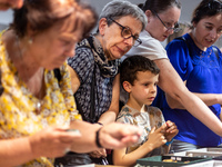 People watch fossils as Polish and exotic insects and reptiles are exhibited by breeders and scientists during an XXII National Insect Day a...