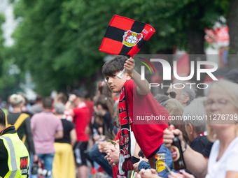 People are waiting for the team of Bayer 04 Leverkusen to arrive at Bay Arena Stadium in Leverkusen, Germany, on May 26, 2024. (