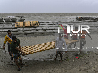 Local people are moving their belongings to another place in Kuakata, Bangladesh, on May 26, 2024, ahead of Cyclone Remal's landfall in Bang...