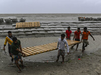 Local people are moving their belongings to another place in Kuakata, Bangladesh, on May 26, 2024, ahead of Cyclone Remal's landfall in Bang...