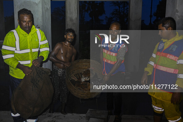 Bangladesh Naval Police members are helping local people take shelter in the Cyclone Shelter in Kuakata, Bangladesh, on May 26, 2024, ahead...