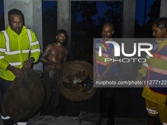 Bangladesh Naval Police members are helping local people take shelter in the Cyclone Shelter in Kuakata, Bangladesh, on May 26, 2024, ahead...