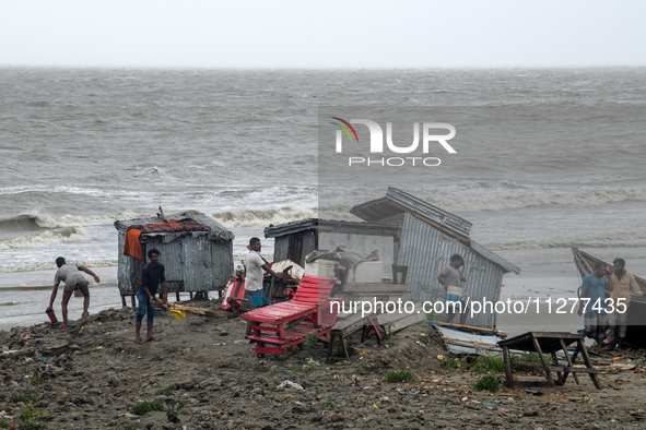 People are moving their goods to a safe place at Kuakata Sea Beach in southern Bangladesh on May 26, 2024, as Cyclone Remal nears. 