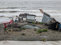 People are moving their goods to a safe place at Kuakata Sea Beach in southern Bangladesh on May 26, 2024, as Cyclone Remal nears. (