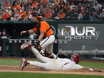 Jason Walk #1 is sliding into home during the 2024 Big 12 Baseball Championship game between the Oklahoma State University Cowboys and the U...
