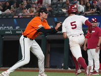 Oklahoma State pitcher Gabe Davis #22 is tagging Michael Snyder #5 of Oklahoma during the 2024 Big 12 Baseball Championship game between the...