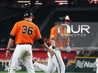 Oklahoma State's Kollin Ritchie #13 is high-fiving his coach Josh Holliday during the 2024 Big 12 Baseball Championship game between the Okl...