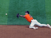 Oklahoma State's Avery Ortiz #15 is making a one-handed play to get the out at second base during the 2024 Big 12 Baseball Championship game...