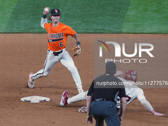 Oklahoma State second baseman Lane Forsythe #6 is trying the double play during the 2024 Big 12 Baseball Championship game between the Oklah...
