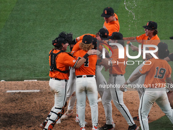 Oklahoma State players are celebrating their victory over Oklahoma during the 2024 Big 12 Baseball Championship game between the Oklahoma St...