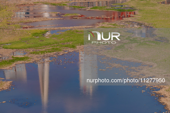 Citizens are playing on the beach of the Jialing River as the water level drops in Chongqing, China, on May 26, 2024. 