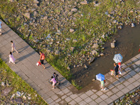 Citizens are playing on the beach of the Jialing River as the water level drops in Chongqing, China, on May 26, 2024. (