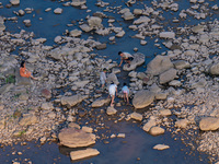 Citizens are playing on the beach of the Jialing River as the water level drops in Chongqing, China, on May 26, 2024. (