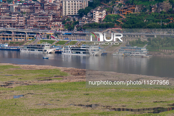 Citizens are playing on the beach of the Jialing River as the water level drops in Chongqing, China, on May 26, 2024. 