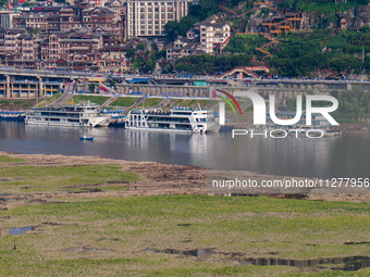 Citizens are playing on the beach of the Jialing River as the water level drops in Chongqing, China, on May 26, 2024. (