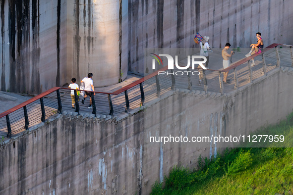 Citizens are playing on the beach of the Jialing River as the water level drops in Chongqing, China, on May 26, 2024. 