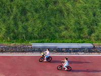 Citizens are playing on the beach of the Jialing River as the water level drops in Chongqing, China, on May 26, 2024. (