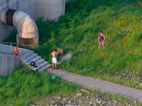 Citizens are playing on the beach of the Jialing River as the water level drops in Chongqing, China, on May 26, 2024. (