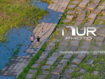 Citizens are playing on the beach of the Jialing River as the water level drops in Chongqing, China, on May 26, 2024. (