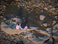 Citizens are playing on the beach of the Jialing River as the water level drops in Chongqing, China, on May 26, 2024. (